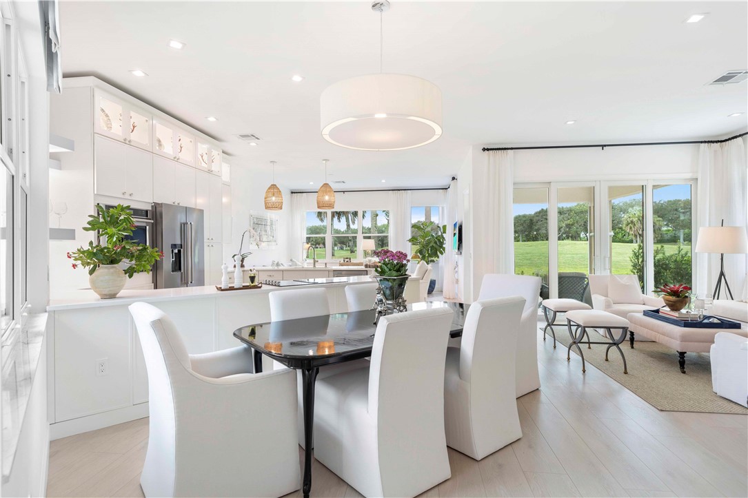 a dining room with furniture and a large window