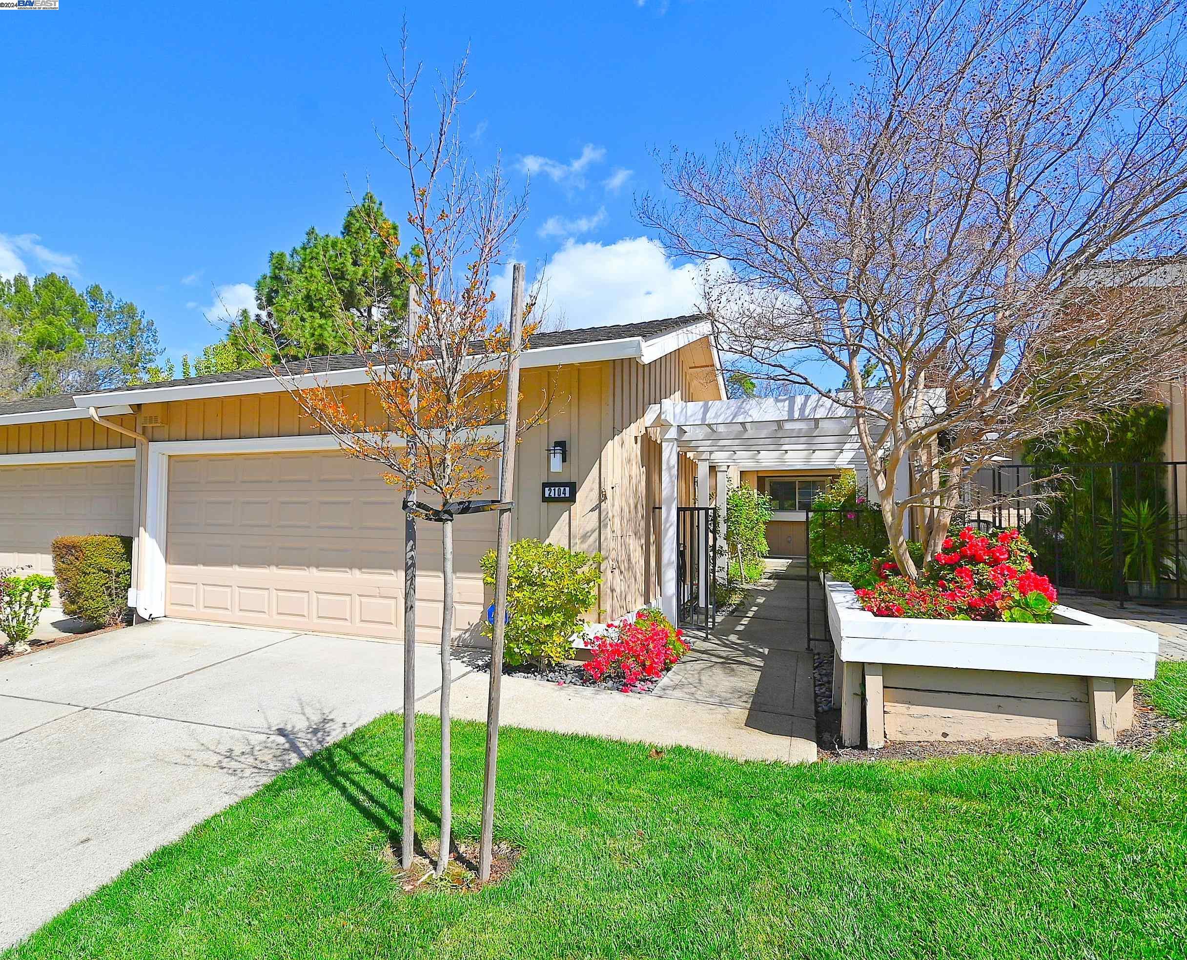 a view of a house with a yard and a fence