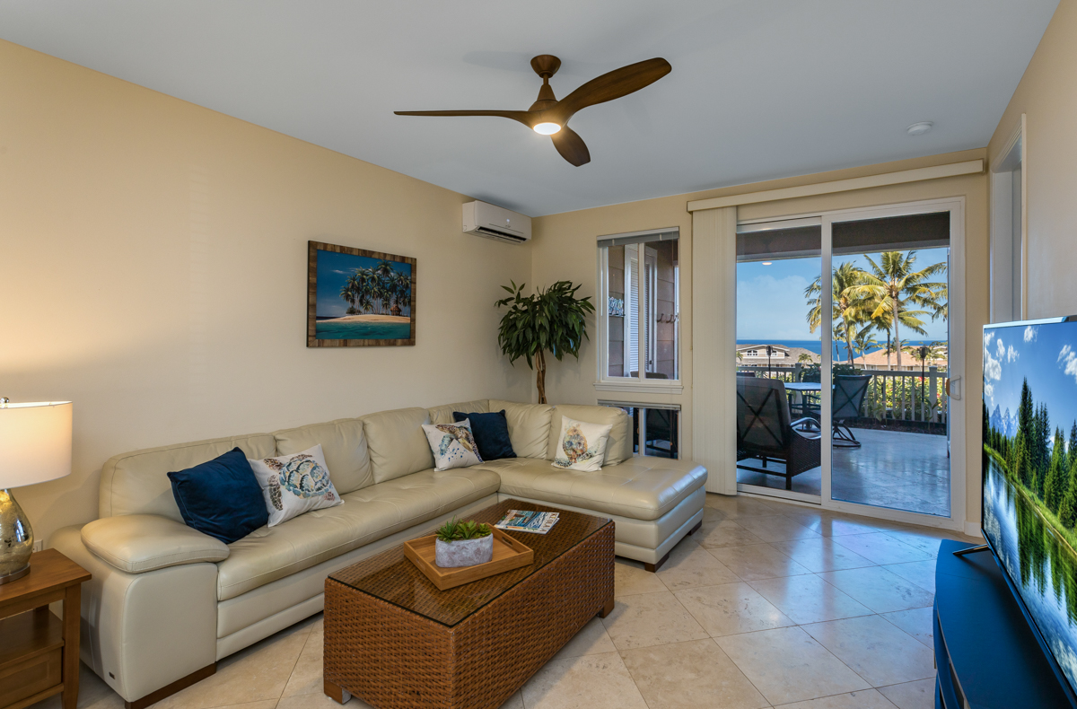 a living room with furniture and a potted plant