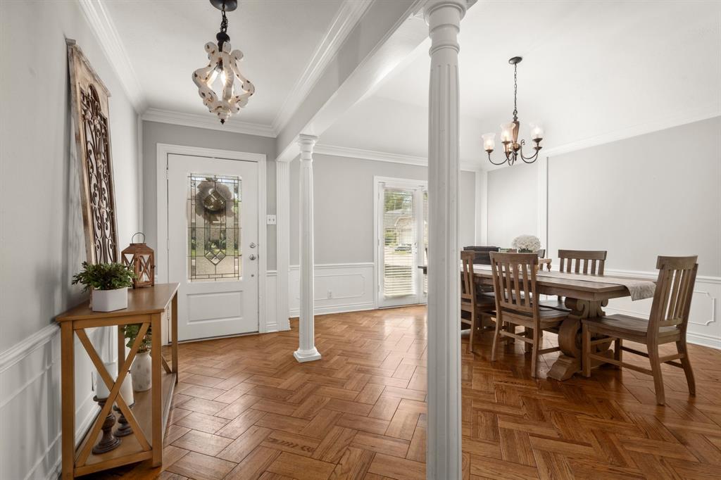 a view of a dining room with furniture and chandelier