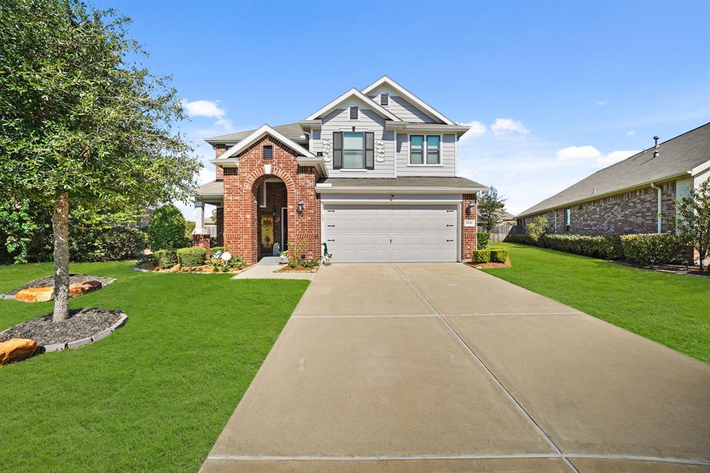 a front view of a house with a yard and garage