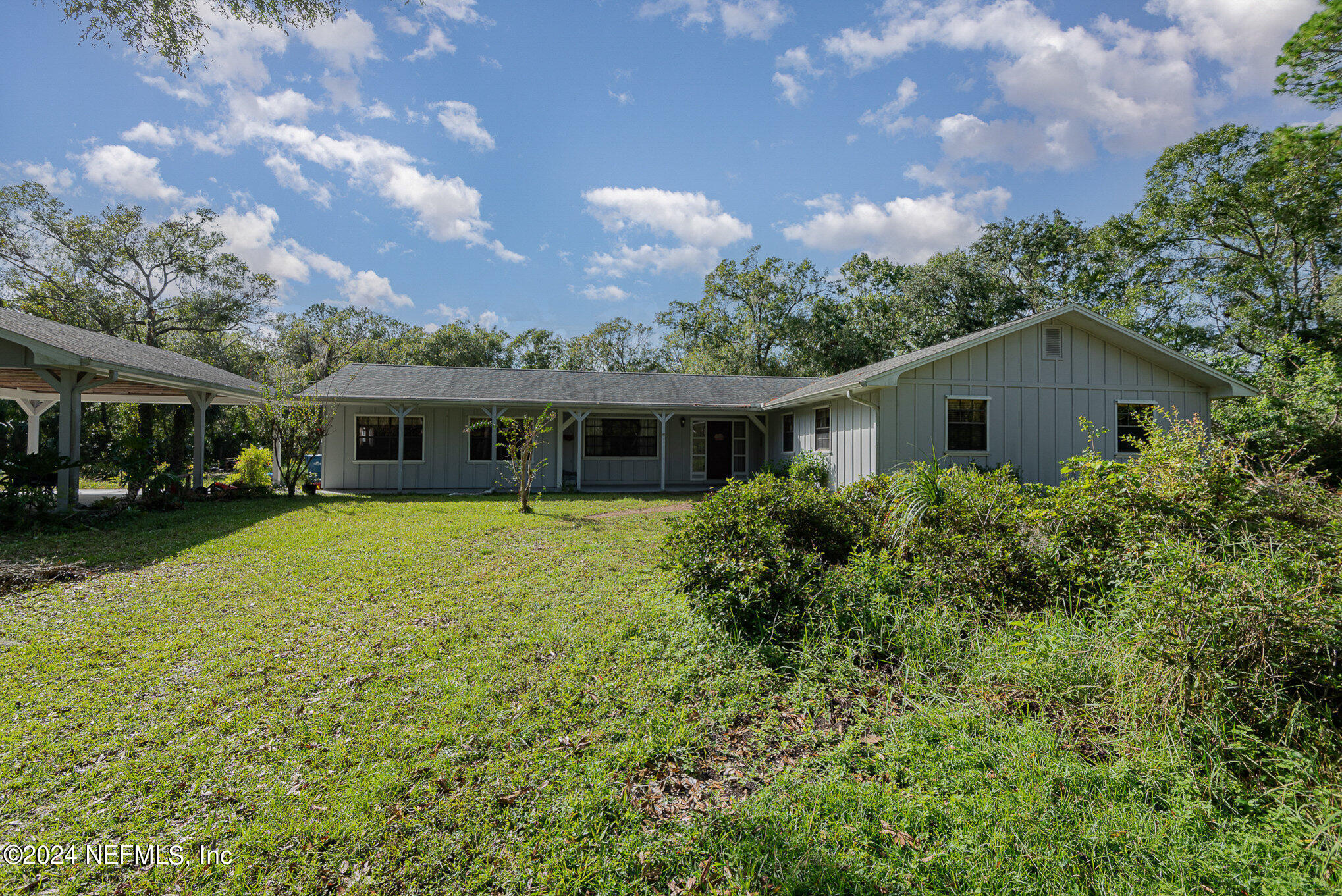 a front view of house with yard and green space