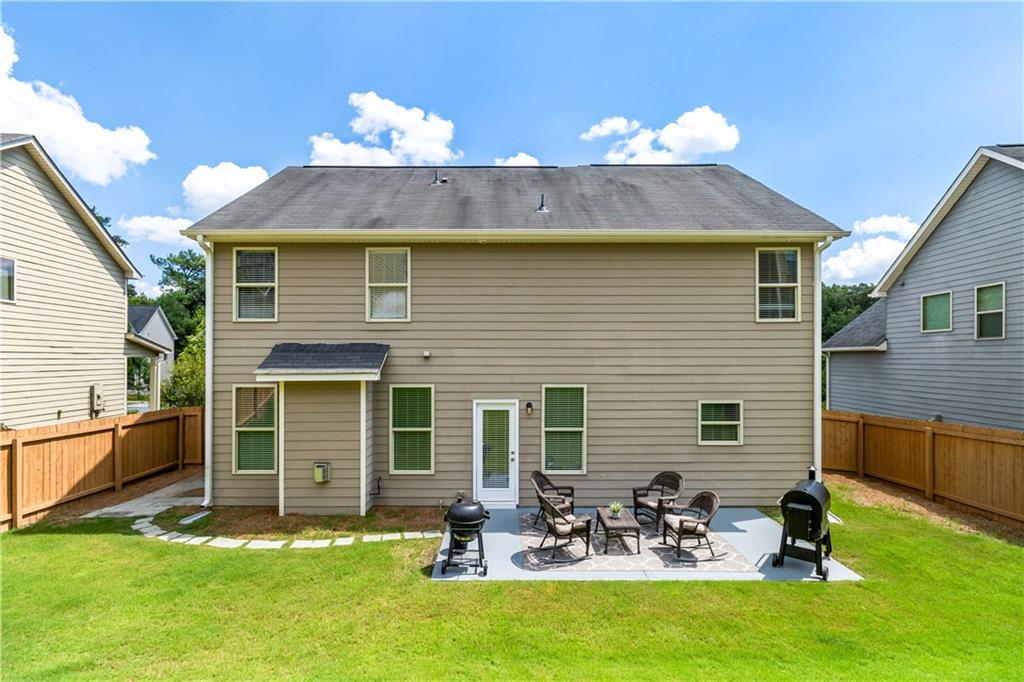 a front view of house with a garden and patio