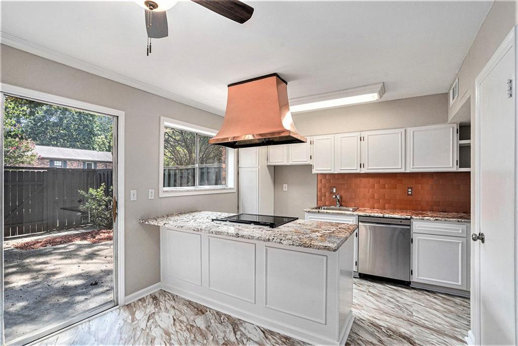 a kitchen with granite countertop a stove and a sink