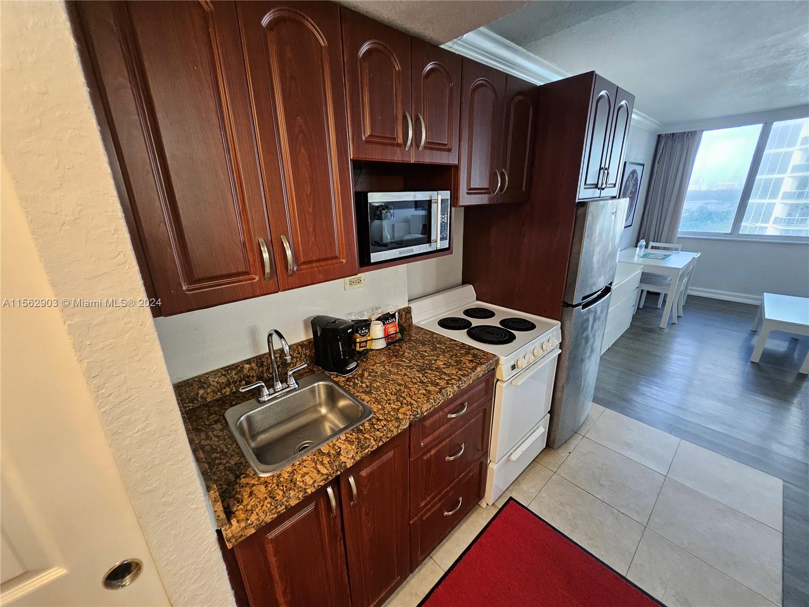 a kitchen with wooden cabinets and a stove top oven