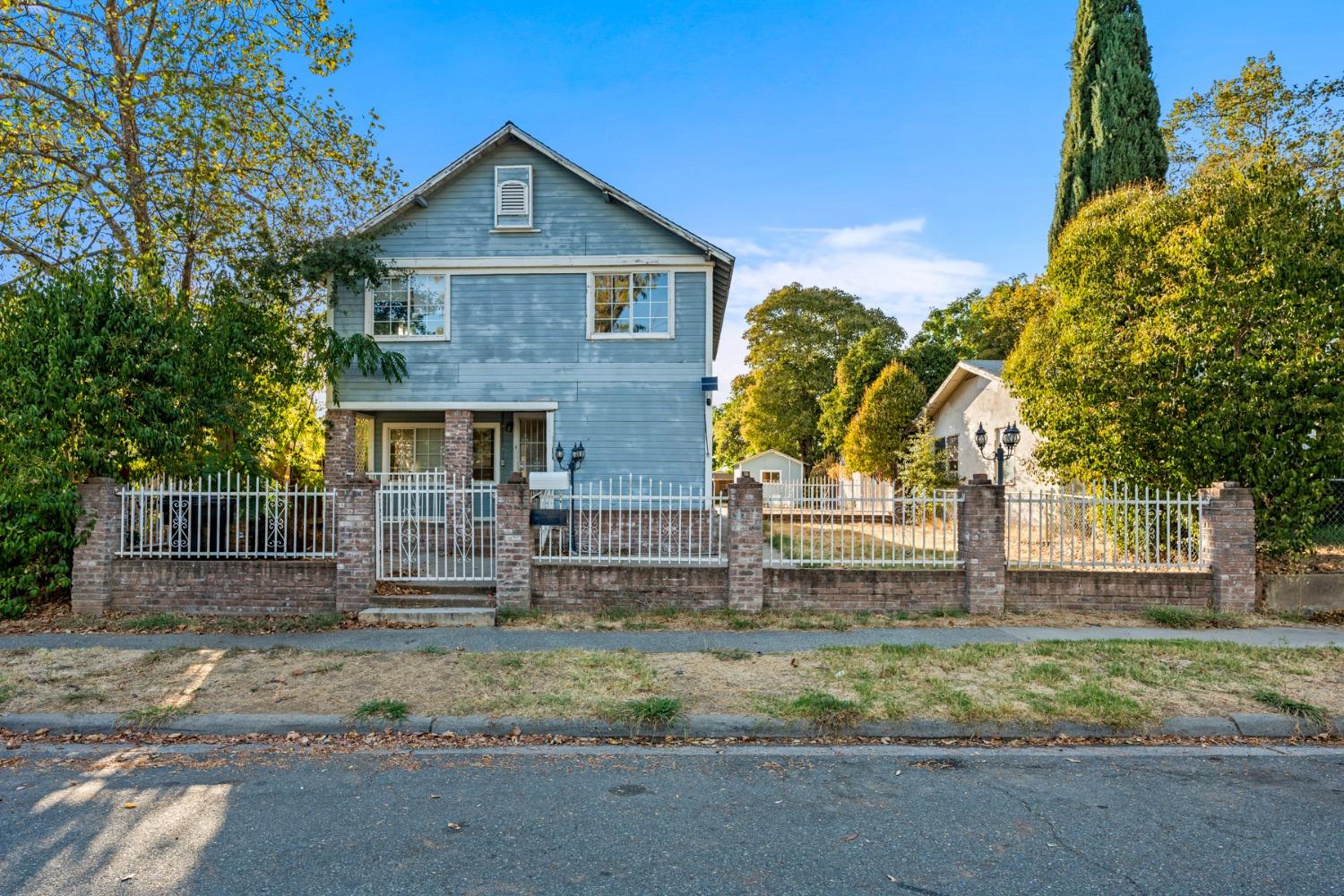 a front view of a house with garden