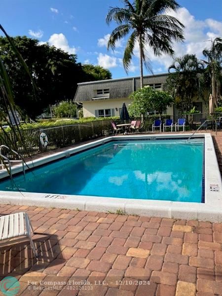 a view of swimming pool outdoor seating and plants