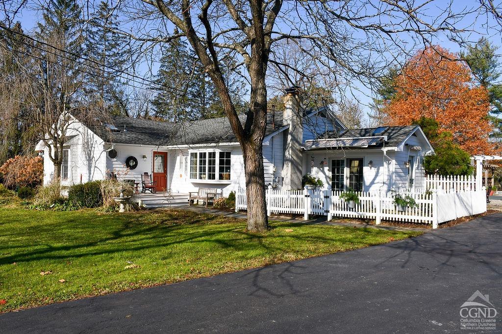 a front view of a house with a yard patio and green space