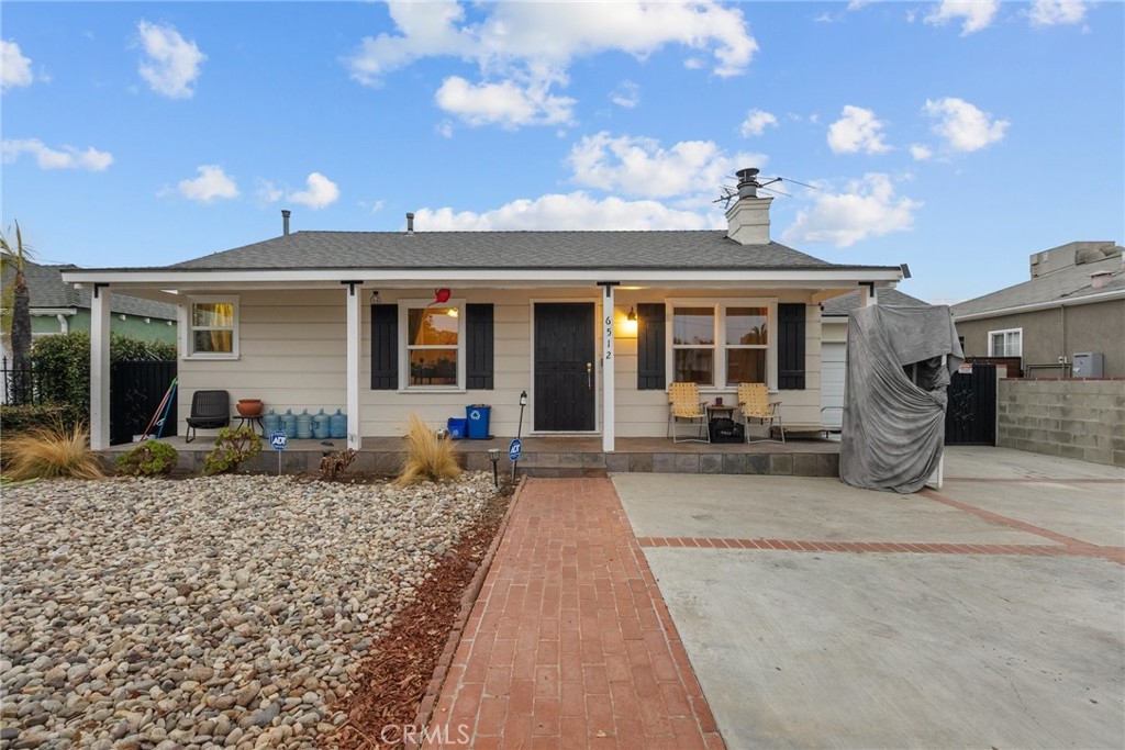 a house view with a sitting space and garden space