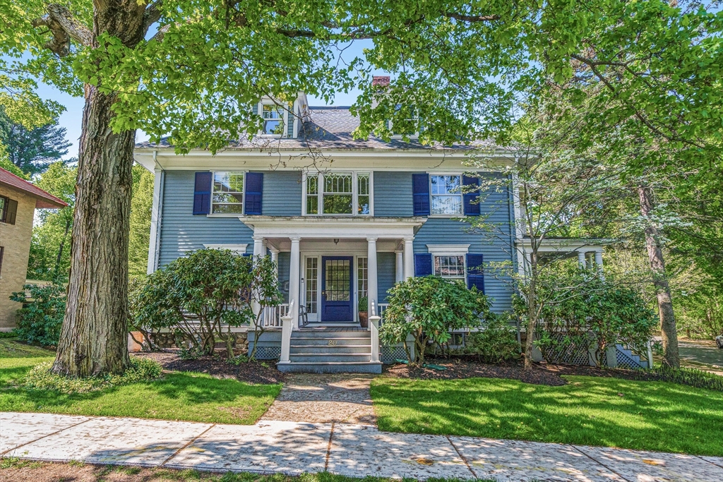 a front view of a house with a garden