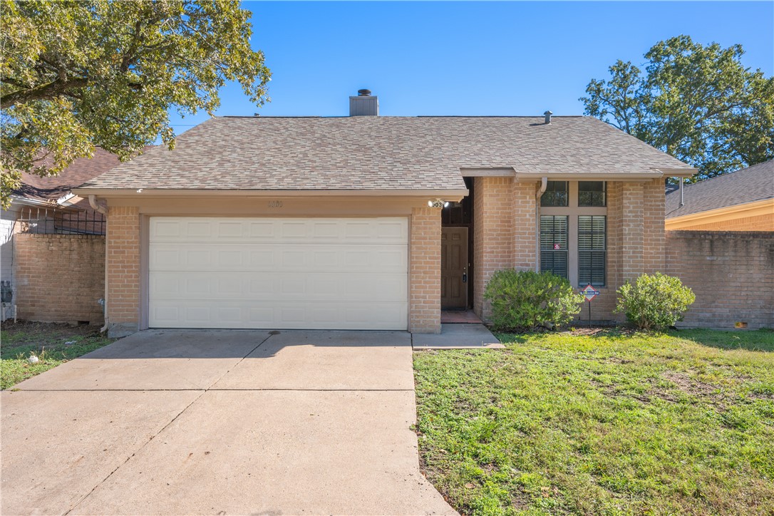 Ranch-style house with a front yard and a garage