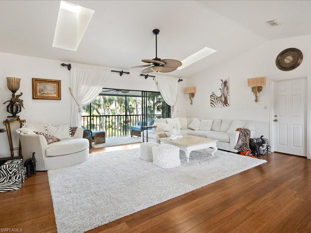 a living room with furniture window and wooden floor