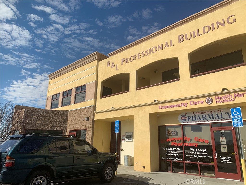 a view of a building with car parked