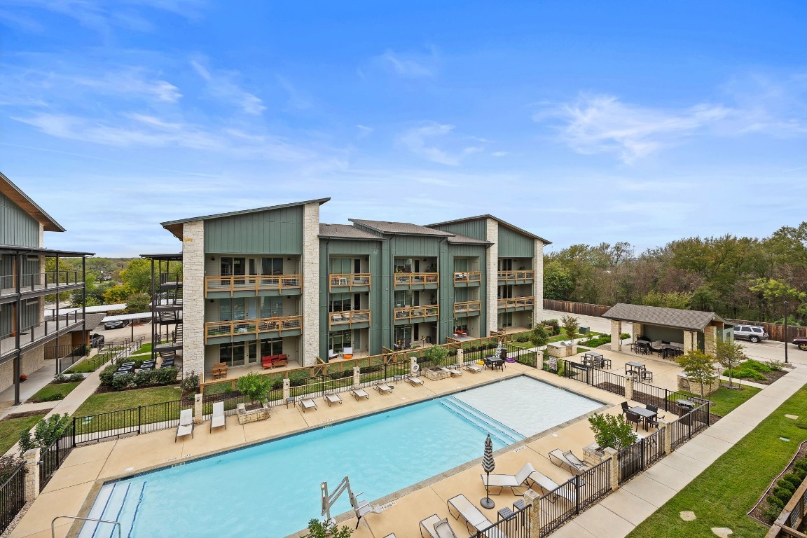 a view of a house with pool and chairs