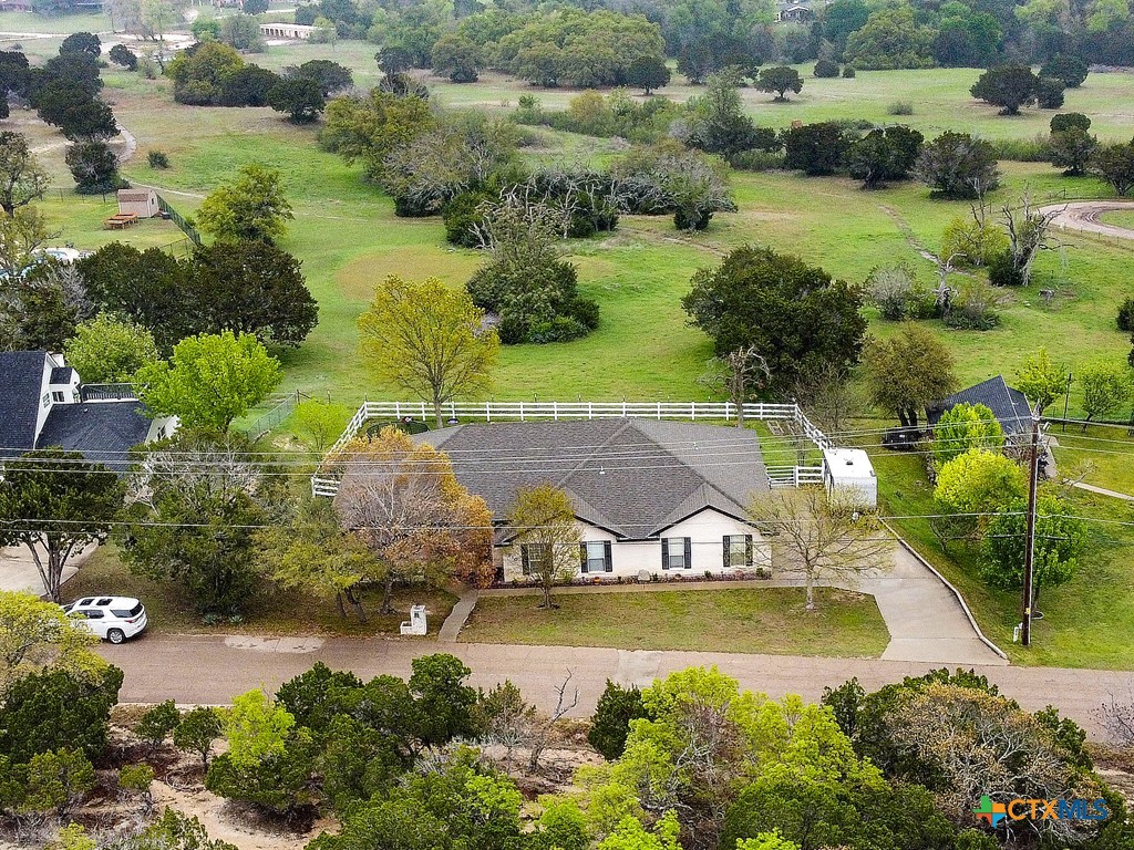 an aerial view of a house with swimming pool and lake view