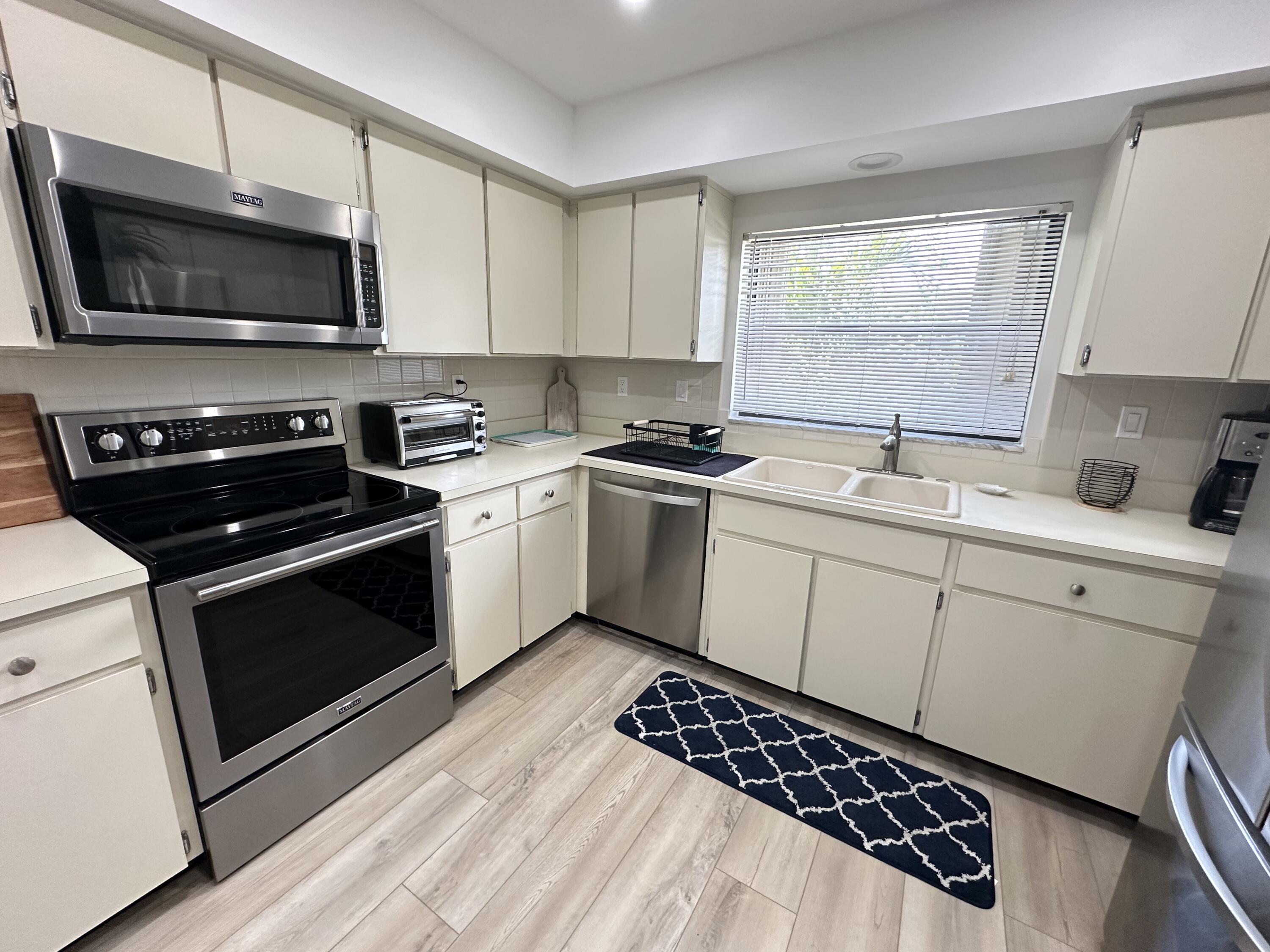 a kitchen with a sink stove and microwave