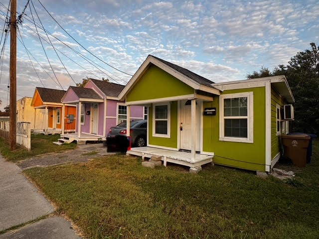 a view of a house with backyard porch and sitting area