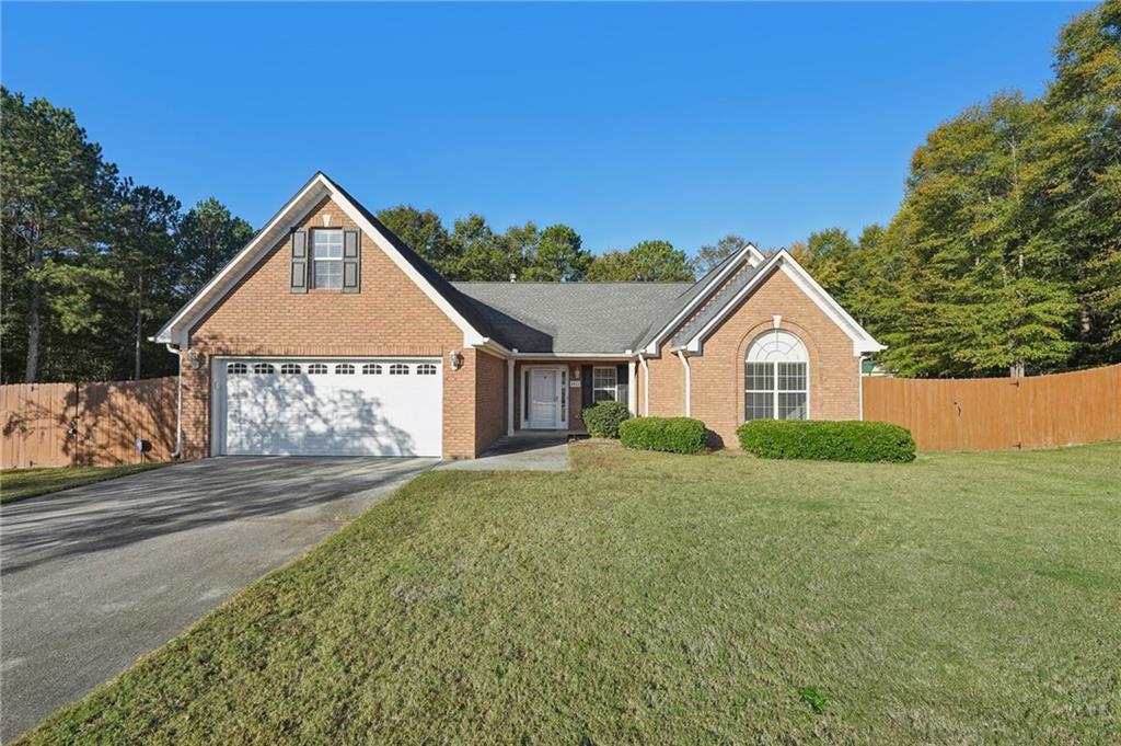 a view of a house with a yard and garage