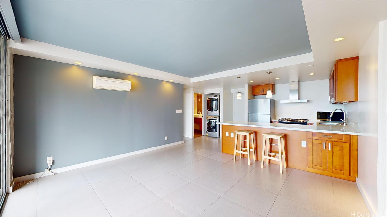 a large white kitchen with stainless steel appliances a refrigerator and a stove