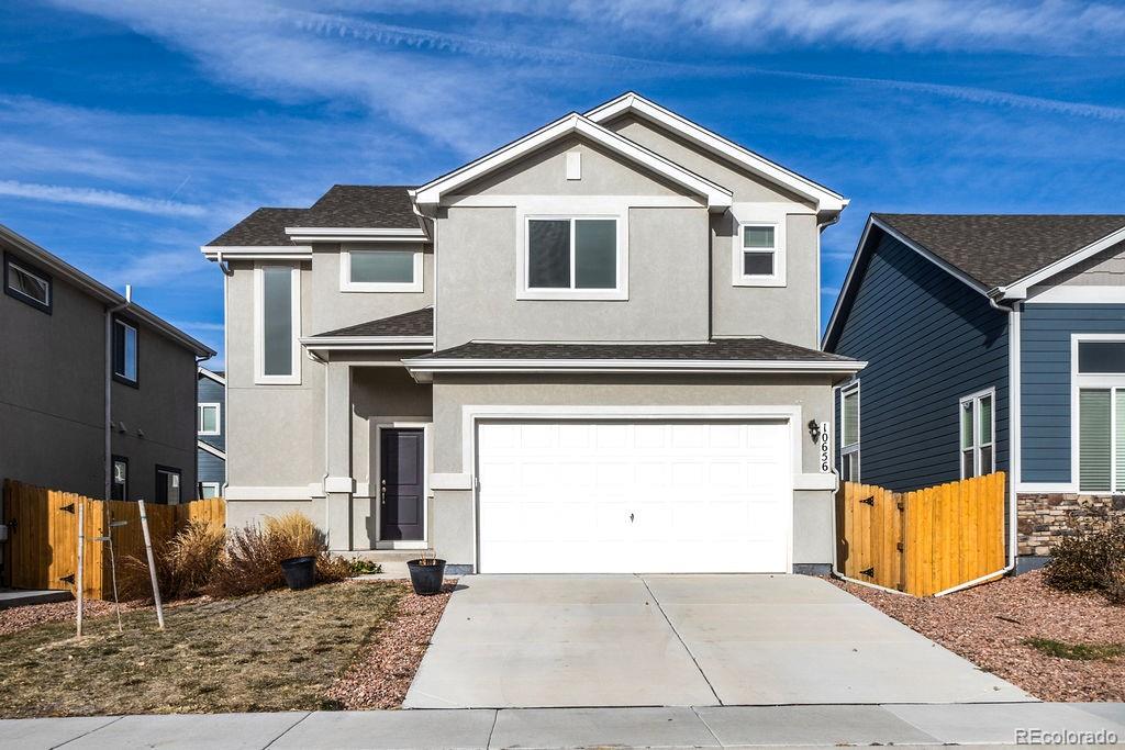 a front view of a house with garage