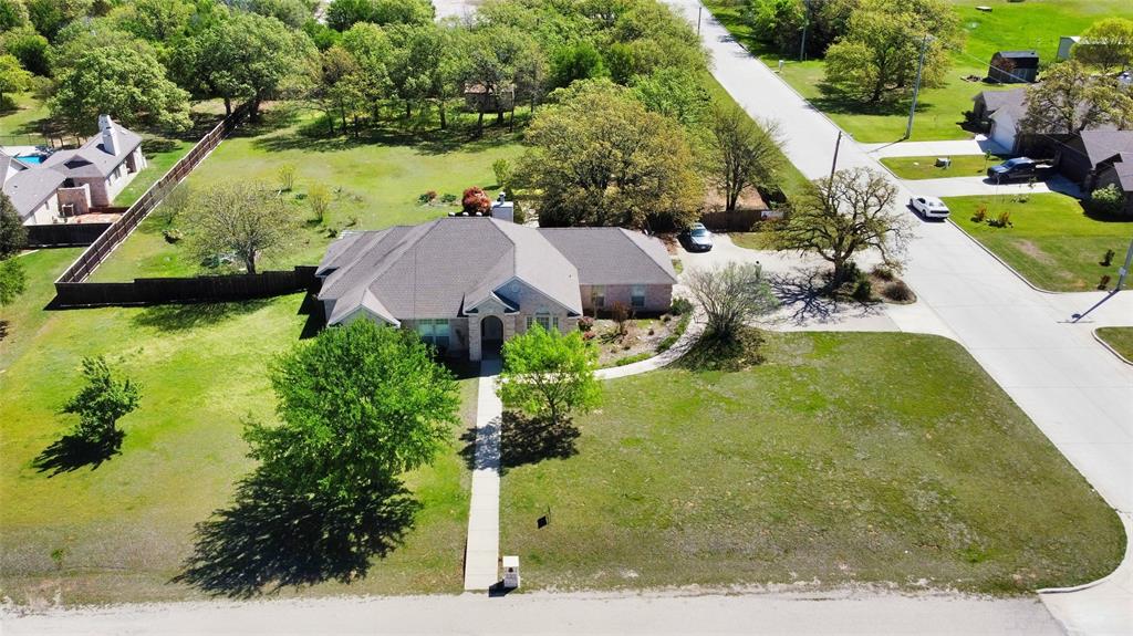 an aerial view of a house with a yard basket ball court and outdoor seating