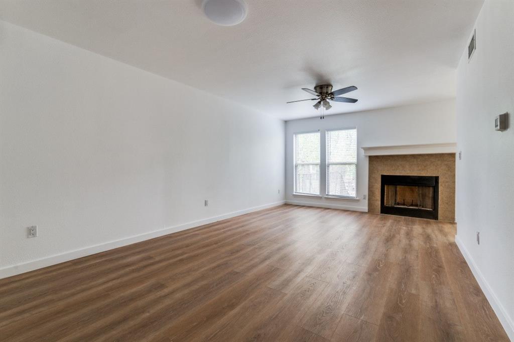 wooden floor in an empty room with a fireplace