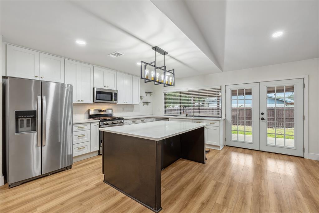 a kitchen with stainless steel appliances granite countertop a stove and refrigerator