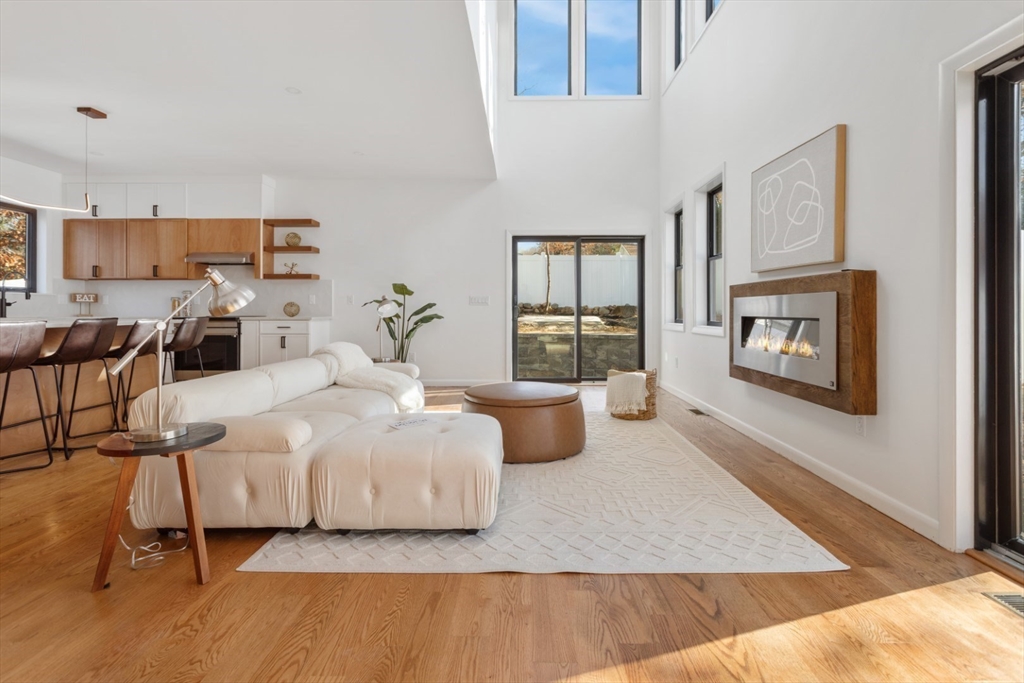 a bedroom with a large bed a fireplace and windows