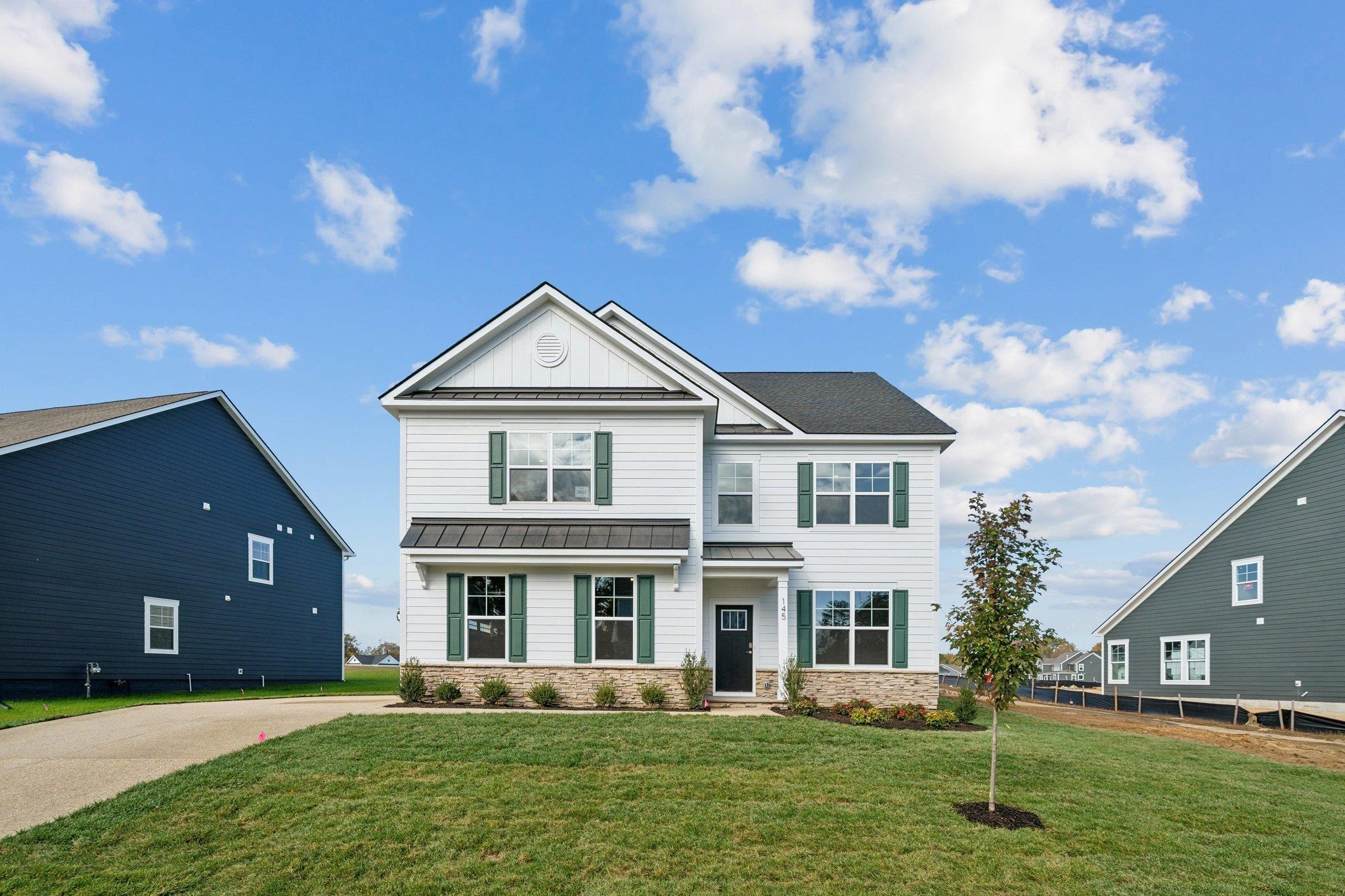 a front view of a house with a yard