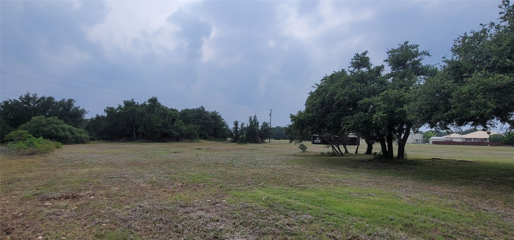 a view of open field with trees in background