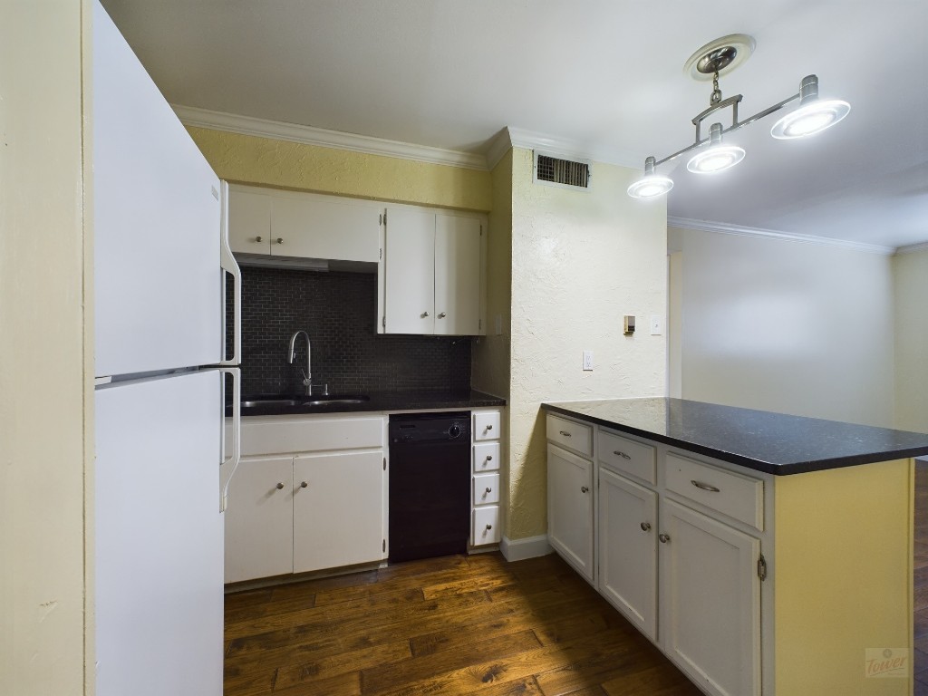 a kitchen with granite countertop a sink and cabinets