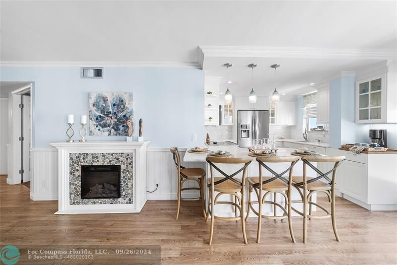 a view of a dining room with furniture and a fireplace