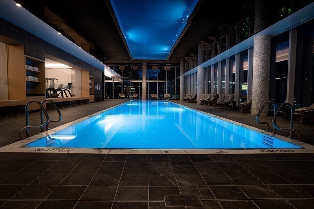 a room with wooden floor and pool table