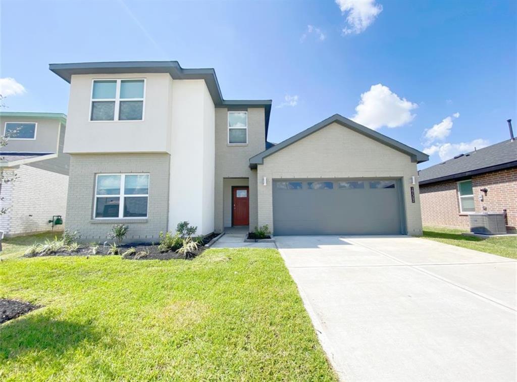 a front view of a house with a yard and garage