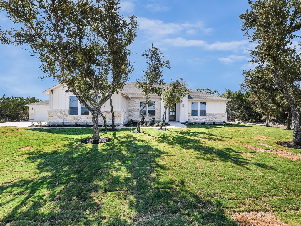 a house view with swimming pool in front of it