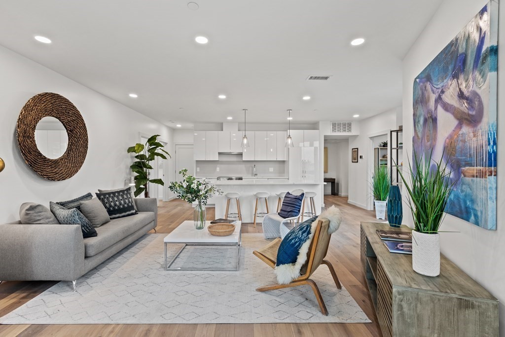 a living room with furniture and a potted plant