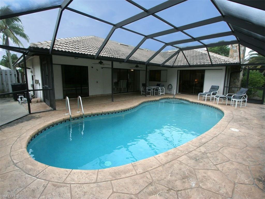 a view of a swimming pool with sitting area