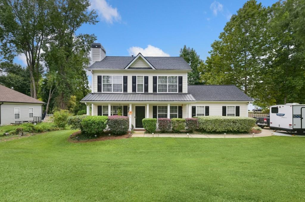 a front view of a house with a garden