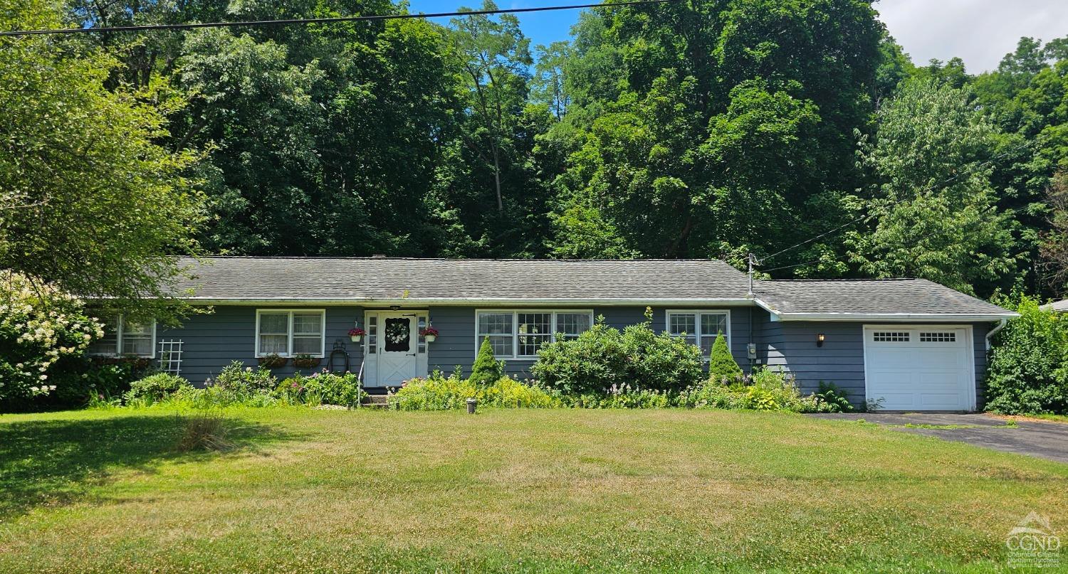 a front view of a house with garden