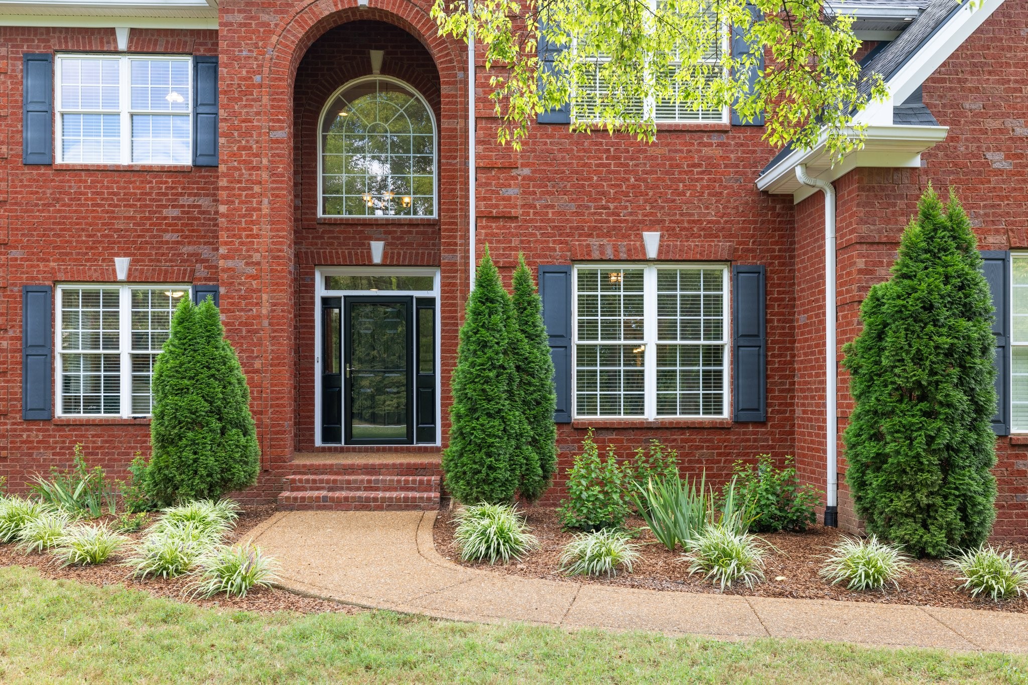 a front view of a house with garden