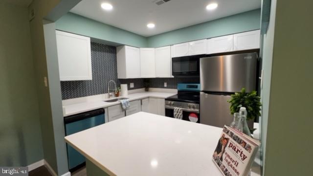 a kitchen with a refrigerator a sink and a stove