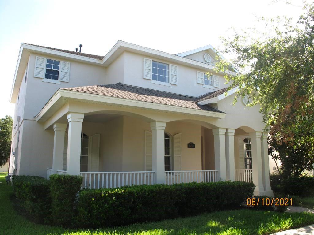 a view of a white house next to a yard