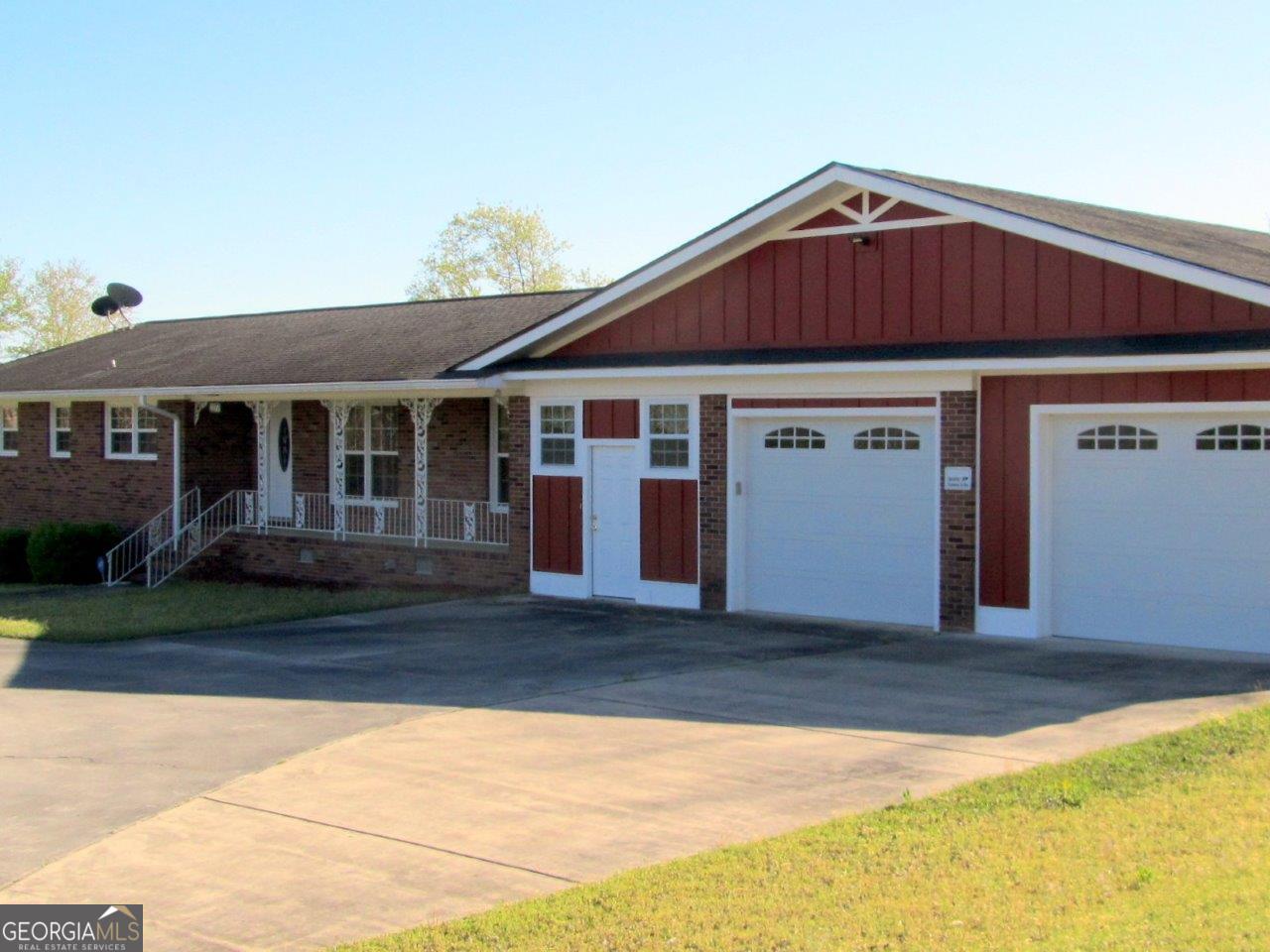 a front view of a house with a garden