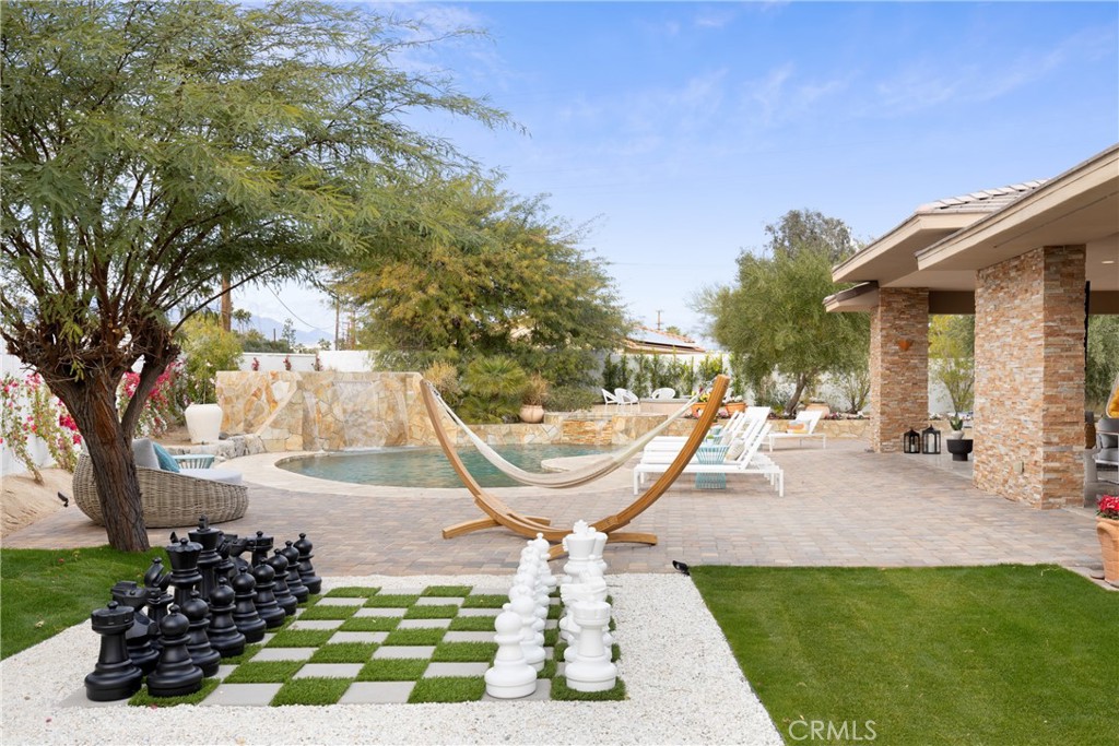 a view of a swimming pool with sitting area