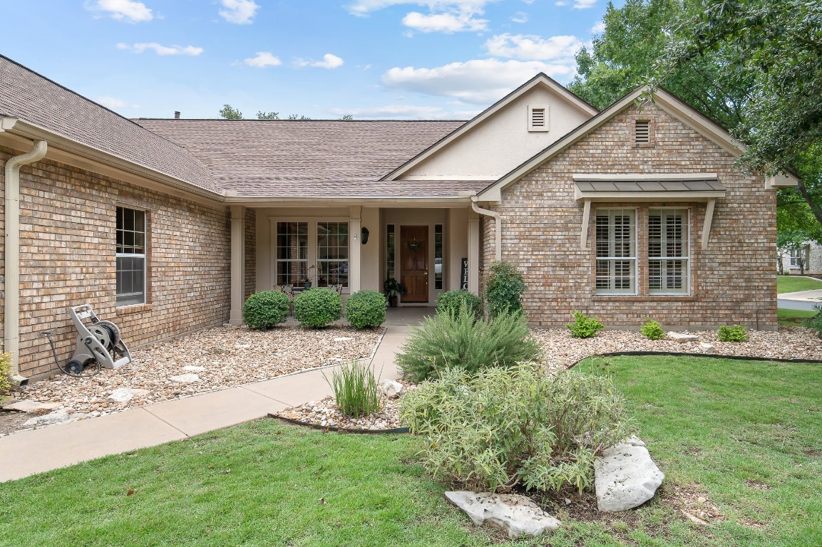 a front view of a house with a yard and porch