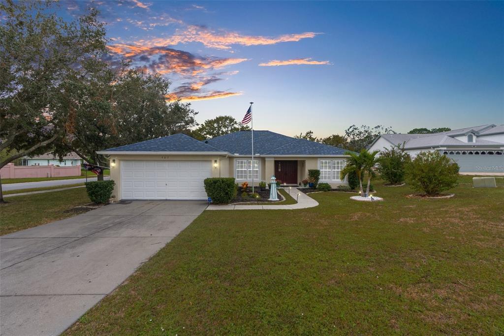 a front view of a house with a yard and garage