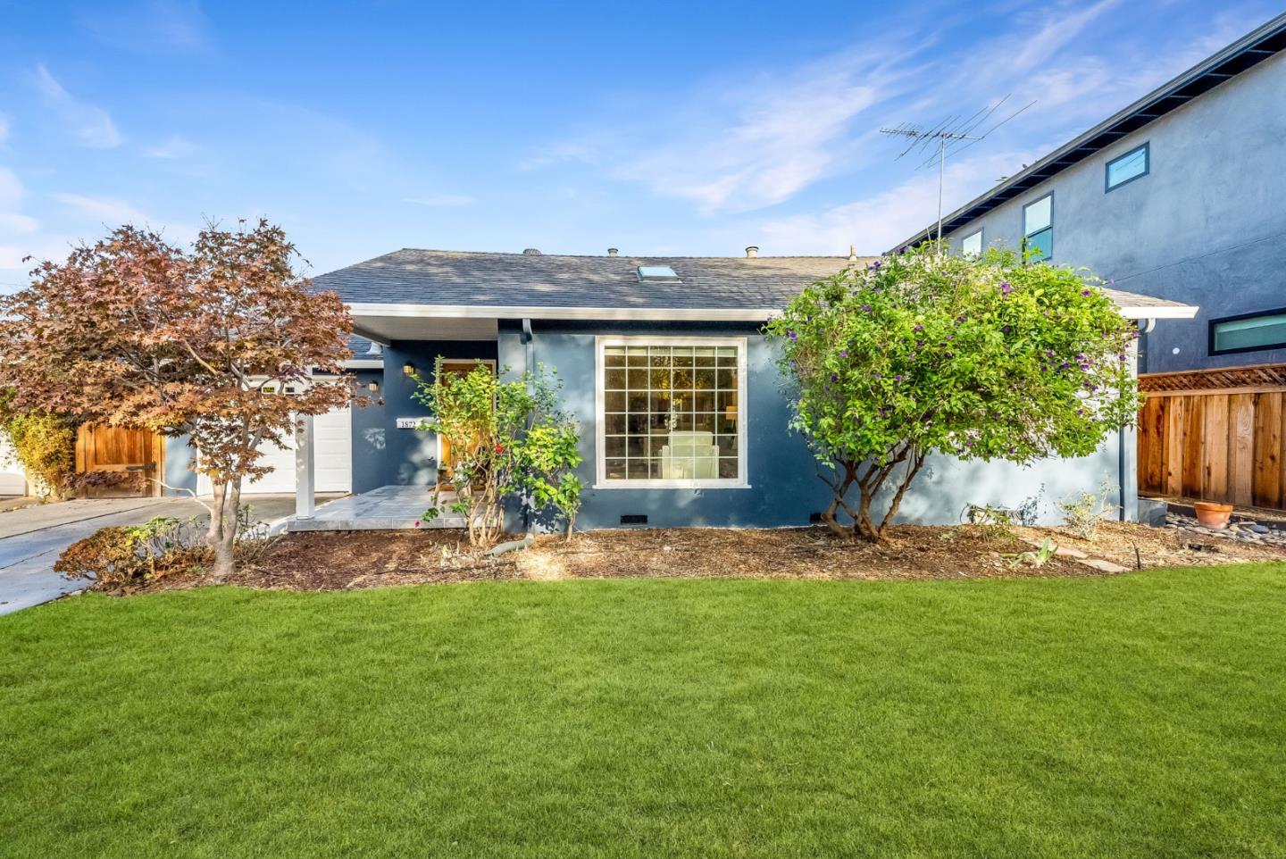 a front view of a house with garden