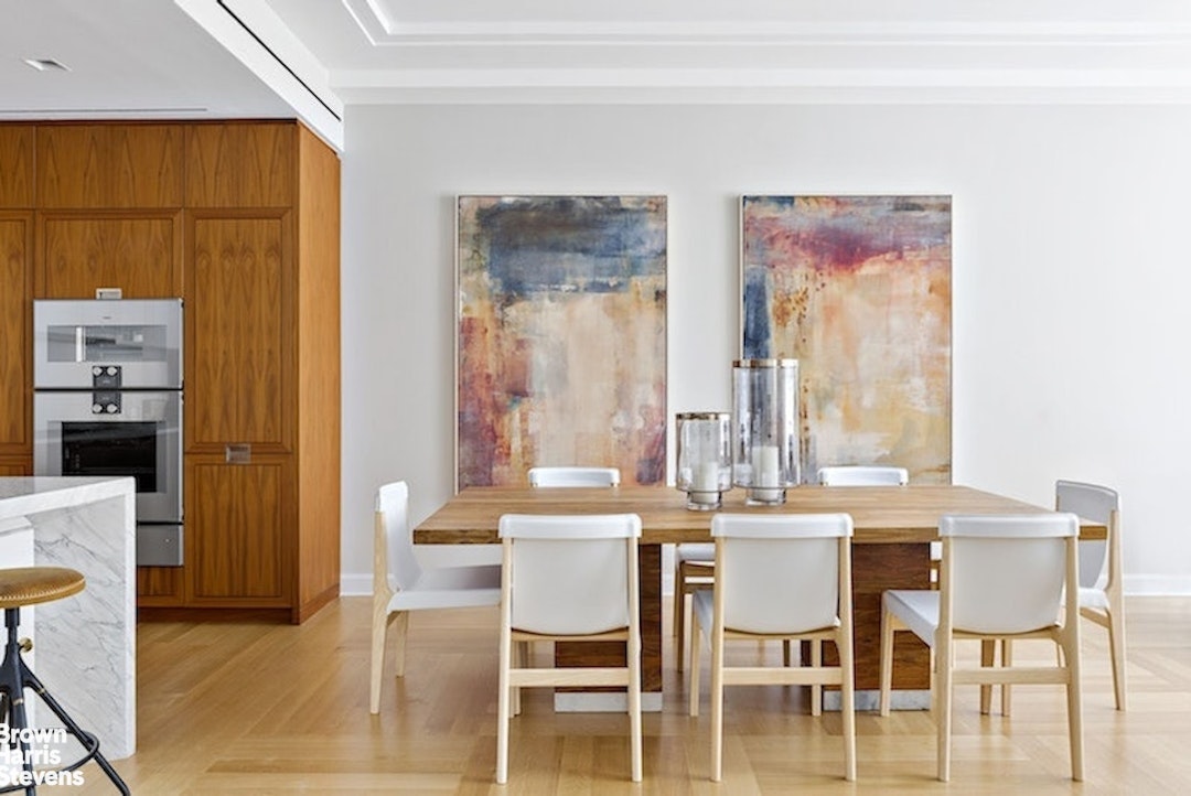 a view of a dining room with furniture and a large window