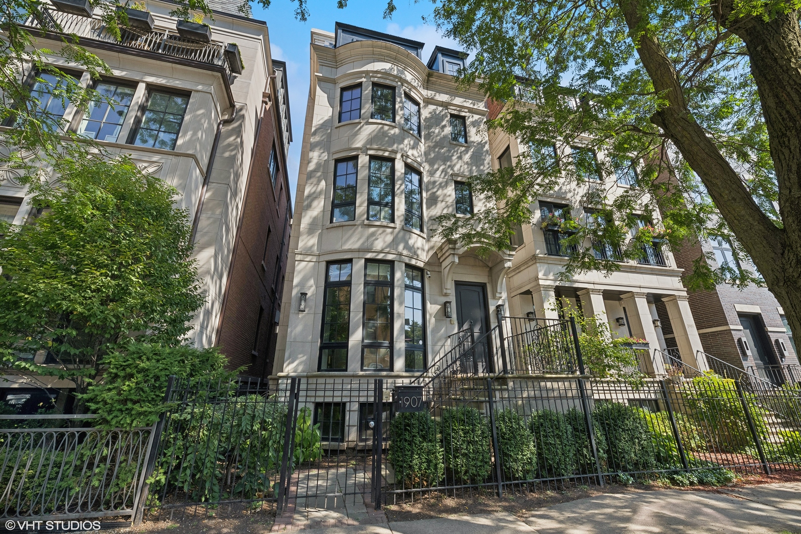 a front view of a multi story residential apartment building with a yard