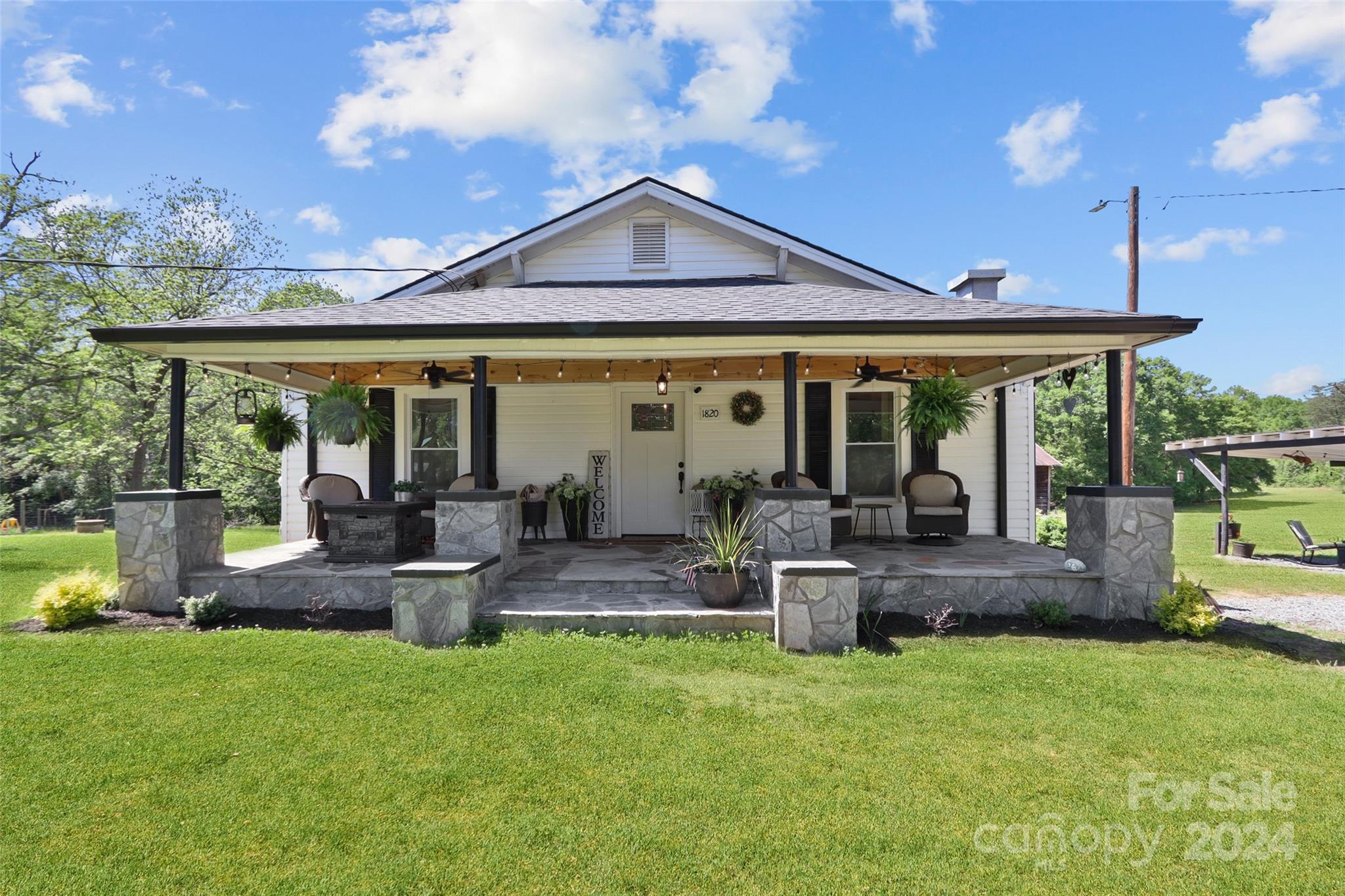 a front view of a house with swimming pool and porch